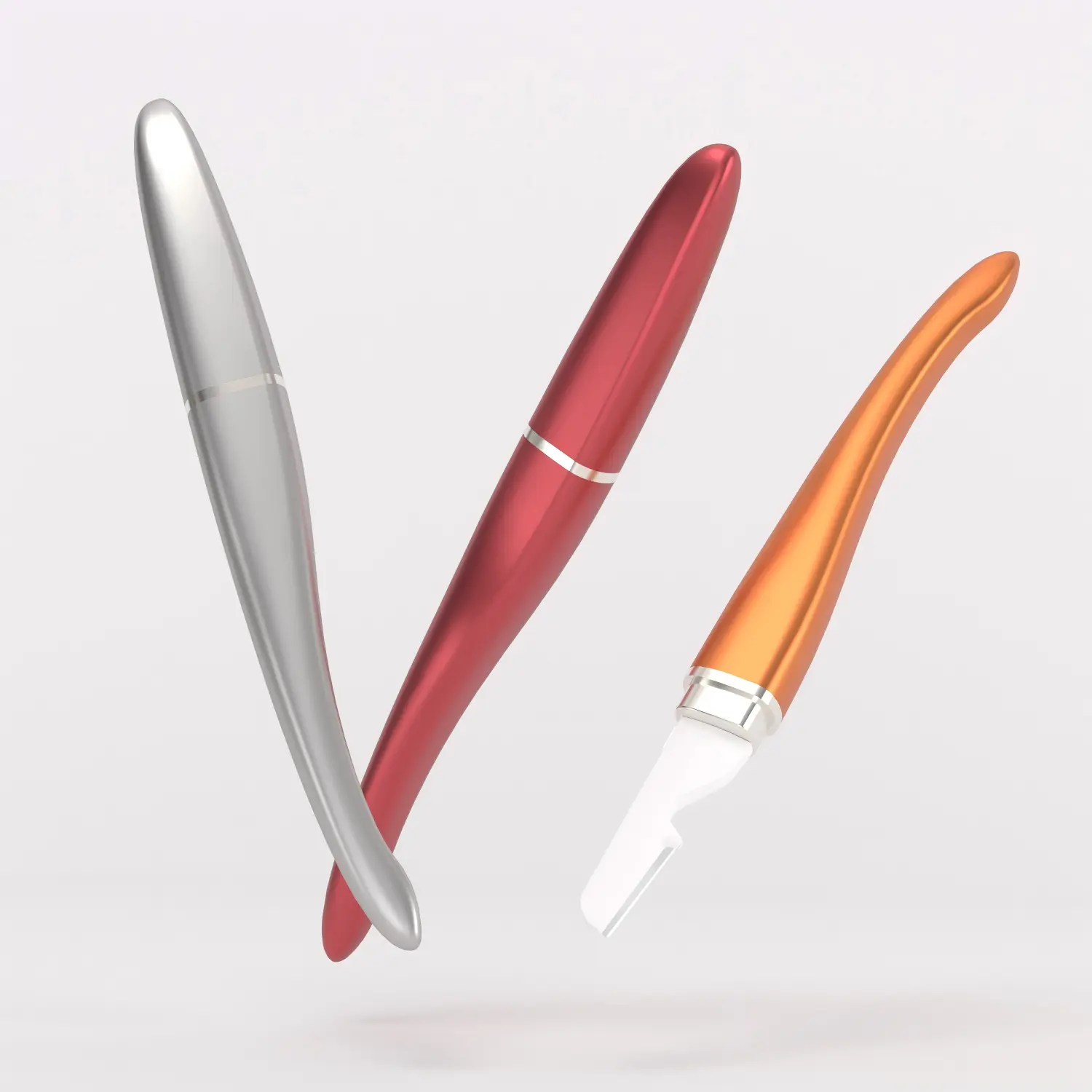 Three curved metal eyebrow razors in silver, red and orange finishes for customizable private label products